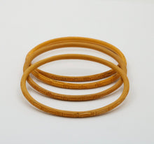 Load image into Gallery viewer, Vintage 1960’s Carved Mustard Yellow Set Four Bangles
