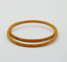 Load image into Gallery viewer, Vintage 1960’s Carved Mustard Yellow Set Four Bangles
