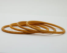 Load image into Gallery viewer, Vintage 1960’s Carved Mustard Yellow Set Four Bangles
